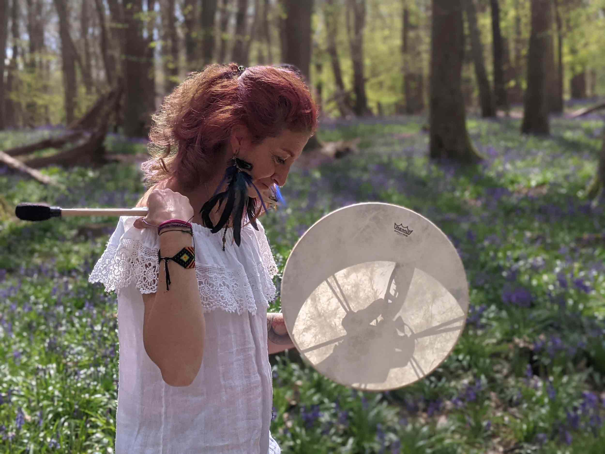 Gloria Urech holding drum in the woods